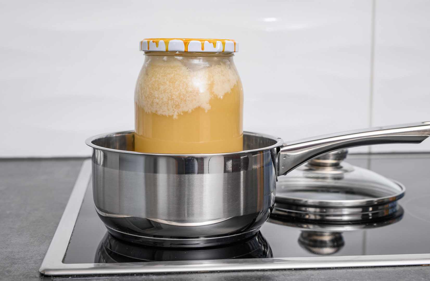 Bring-Crystallized-honey-back-to-liquid form --Real bee honey heated in warm water in a pot